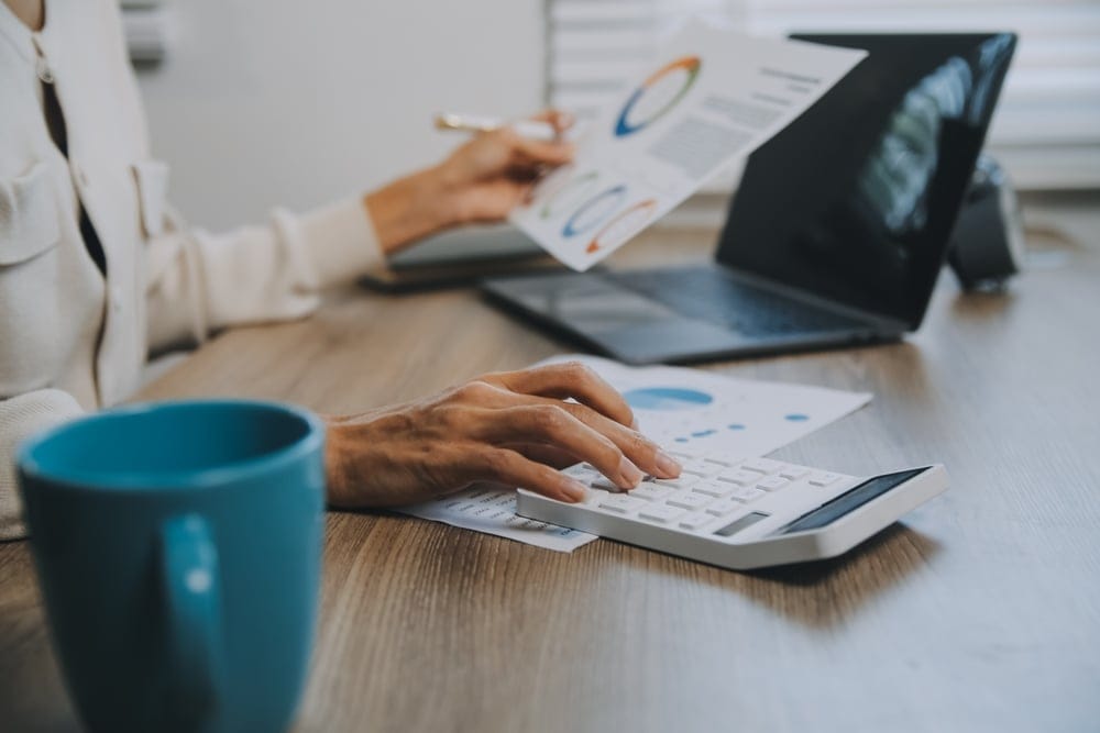 Businessmenarecalculatingincome expenditureandanalyzingrealestateinvestmentdata